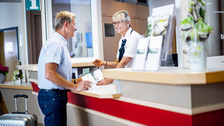 Patient checkt an der Rezeption ein