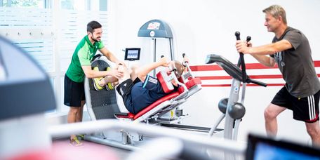 Therapeut weist Patienten in Geräte ein