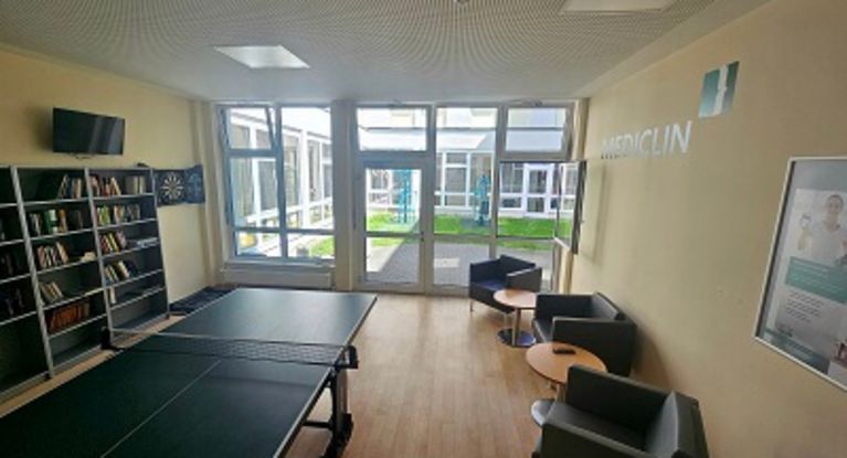 Freizeitraum im Reha-Zentrum Spreewaldmit Sofa und Bücherregal